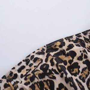Detailed view of the leopard print corset stitching and multi-panel fabric construction