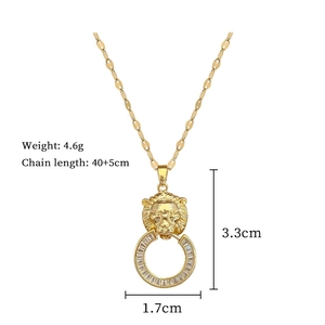 Macro detail of gold lion head pendant with dimensions 3.3cm by 1.7cm and zircon stones