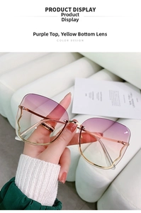 Detail of rimless gradient purple and yellow lenses with gold metal temples on sunglasses