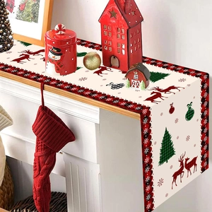 Christmas table runner with reindeer and trees on a mantelpiece with festive ornaments