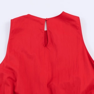 Detailed close-up of red midi dress back neckline with button and teardrop cutout