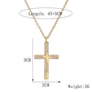 Detail view of gold cross necklace with crystal zircon showing 45+5cm length dimensions