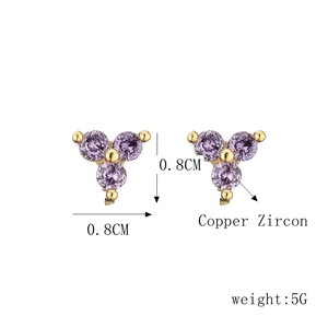 Detail of 0.8cm gold copper studs with three purple zircons in triangular layout