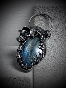 Vintage silver skull pendant featuring a large oval blue labradorite stone with mystic glow
