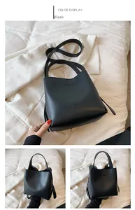 Front and side profile of a black leather bucket bag with brand embossing and strap