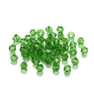 Macro detail of emerald green faceted bicone glass crystal beads for DIY jewelry