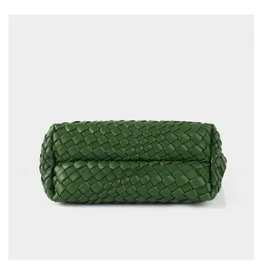 Detailed base view of deep green hand-woven leather tote bag with wide strap pattern