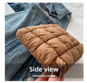 Detail shot of the brown quilted makeup bag showing its padded texture and side thickness