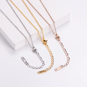 Detailed trio of 18KGP rose gold, silver, and gold rose flower necklaces on white marble