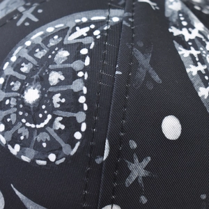 Close-up of bohemian paisley print on black cotton twill with reinforced stitching