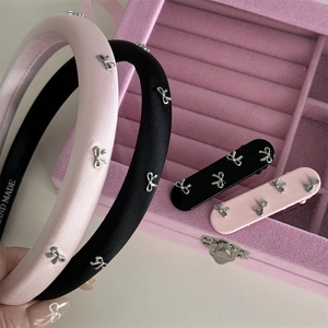 Pink and black satin bow headbands and hair clips set in a velvet jewelry box