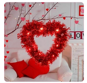 Macro shot of red heart tinsel wreath with LED lights and festive Valentine decor
