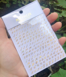 Detail showing 3D gold alphabet nail stickers with cursive English letters WG720