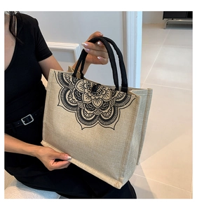 Close-up of linen tote bag showing woven texture and black mandala floral print