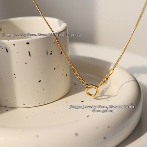 Close-up of minimalist 18K gold plated titanium steel necklace with a circle pendant
