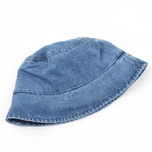 Close-up of blue denim bucket hat showing fabric texture and metal ventilation eyelets