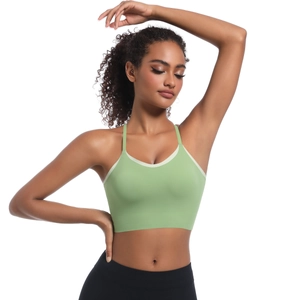 Close-up of seamless light green yoga bra with beige contrast trim and high elasticity