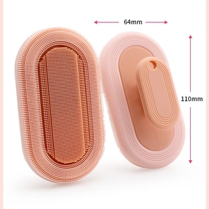 Pink silicone baby bath brush with dimensions 64mm by 110mm shown from both sides