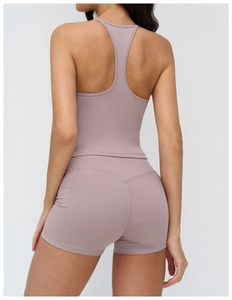 Rear view of dusty pink racerback yoga tank top and high waist sports shorts set