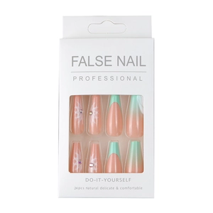 French gradient press-on nails set with white floral prints and small rhinestones
