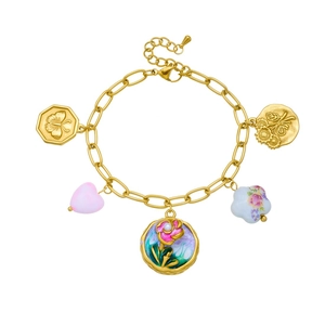 Detailed shot of golden chain bracelet with floral enamel charms and colorful resin beads