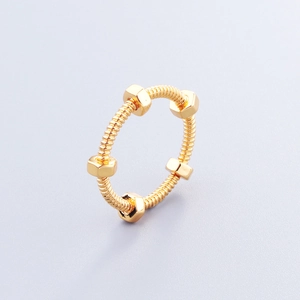 Detailed close-up showing the industrial gold spring nut ring with polished metallic texture