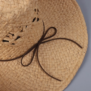 Handwoven straw cowboy hat with a brown leather cord and breathable hollow crown design