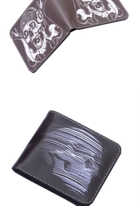 Detail of dark brown bifold wallet with skull print and white contrast stitching