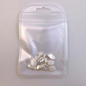 Clear plastic packaging bag containing white baroque irregular nail art pearl charms