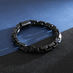 Close-up of black matte titanium steel chain bracelet on a blue and black background