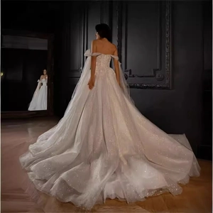 Sparkling off-the-shoulder wedding dress with long train and glitter fabric detail