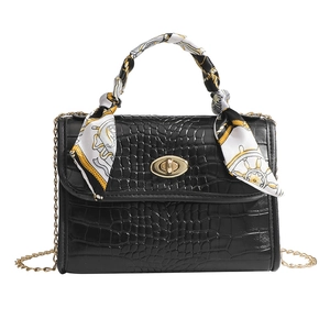 Black crocodile texture bag with gold chain and printed silk scarf wrapped handle