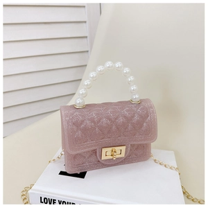 Close-up of pink jelly bag with pearl handle, diamond quilting and glitter finish