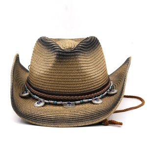 Detail of western straw hat featuring leather band with turquoise beads and silver metal discs