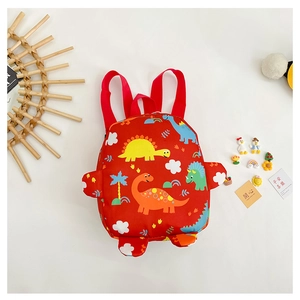 Detail of red toddler backpack with colorful cartoon dinosaur prints and 3D fin accents