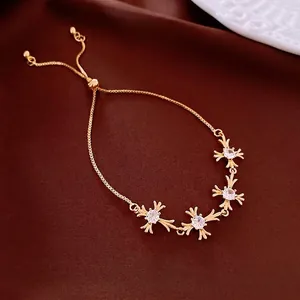 Adjustable 18K gold-plated zircon cross flower bracelet on elegant dark silk fabric