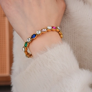 Detailed macro view of vintage gold bracelet featuring colorful rhinestones and crystals