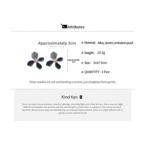 Detail view of denim flower earrings with imitation pearls and silver needles specifications