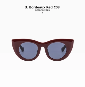 Detail der bordeauxroten Cat-Eye-Sonnenbrille mit blau-grauen Gläsern und Rahmen