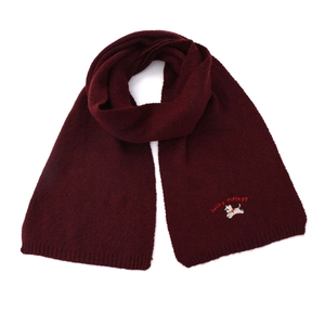 Detail of burgundy knitted scarf featuring white puppy embroidery and lucky text pattern