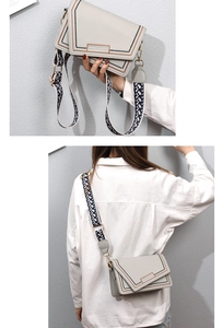 Detail of beige PU crossbody bag featuring geometric lines and wide patterned shoulder strap
