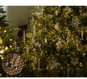 Detail of clear acrylic crystal snowflakes and icicles hanging on a Christmas tree