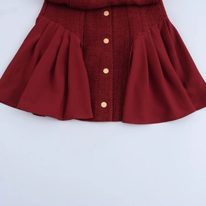 Dark red tweed patchwork dress with gold buttons and pleated hem on white background