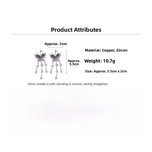 Detailed view of butterfly tassel earrings with purple cubic zirconia and silver pins