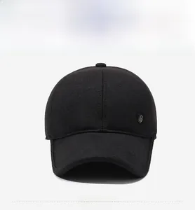 Front view of black winter baseball cap with thick knit texture and metal shield logo