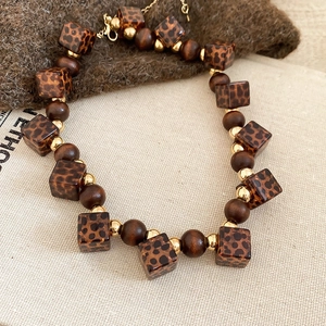 Vintage acrylic leopard square beads and wooden beads necklace set on linen fabric