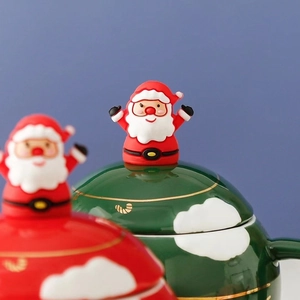 Christmas tree ceramic mug with Santa figurine lid and gold rim in festive green