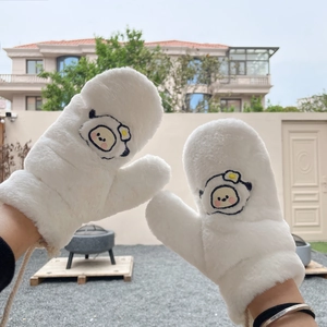 Detail of white plush mittens featuring cartoon embroidery and functional lanyard for winter