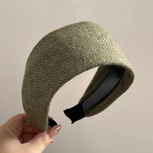 Detail of olive green herringbone wool wide headband with vintage textured fabric