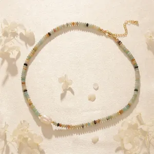 Detail of beaded tiger eye necklace featuring a baroque pearl and gold lobster clasp